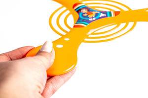 Orange boomerang in hand, close-up