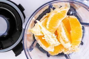 Orange fruit sliced in the juice mixer