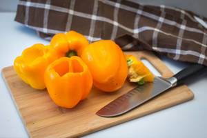 Orange Peppers on a Cutting Board with Knife