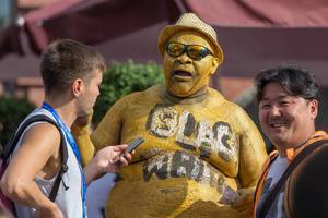 Overweight man with golden body pain being interviewed