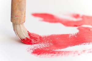Paint brush with red color for creative art work