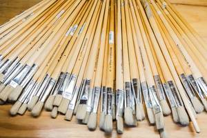 Paint brushes on wooden surface