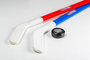 Pair of hockey sticks and puck on a white background