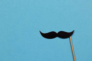Paper mustache on blue background