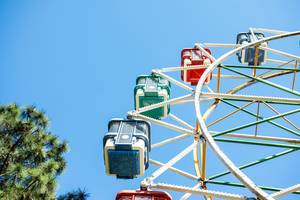 Part of a ferris wheel with blue sky behind