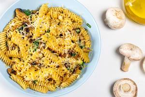 Pasta with mushrooms, cheese and spinach. View from above (Flip 2019)