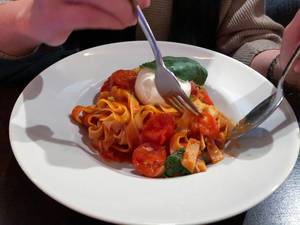 Pasta with tomato sauce, cherry tomatoes, fresh burrata and basil
