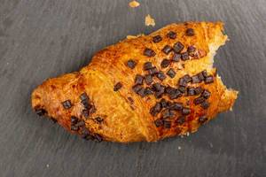Pastry Croisant with Chocolate Crumbs on the stone tray (Flip 2019)
