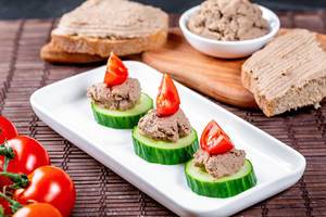 Pate on toast and cucumber slices with tomatoes