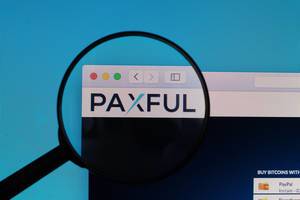Paxful logo under magnifying glass
