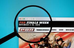 PBR World Finals website on a computer screen with a magnifying glass.jpg
