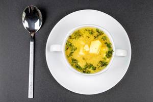Pea soup with dill greens in a tureen on a black background, top view (Flip 2020)