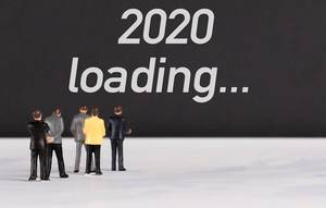 People standing in front of 2020 loading text