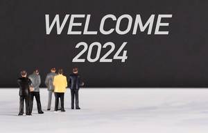 People standing in front of Welcome 2024 text
