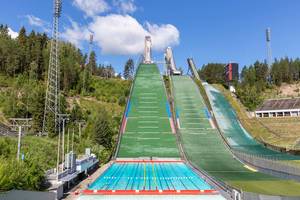 People swimming in the unique swimming pool at the foot of ski jumping ground Salpausselkä, during summer season, in Lahti, Finland