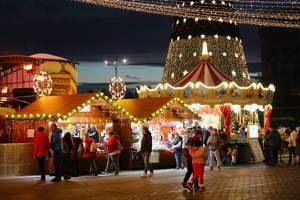 People visiting Bucharest Christmas fair at night