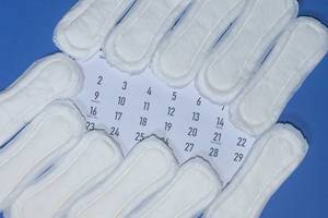 Period days concept. Sanitary napkins and calendar