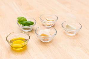 Pesto ingredients: olive oil, Parmesan, garlic, pine nuts and basil