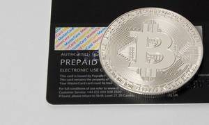 Physical bitcoin on a backside of a Mastercard