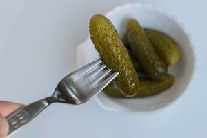 Pickled Cucumber - Pickle - on a steel fork
