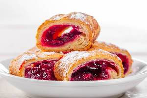 Pieces of cherry strudel on a white plate