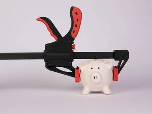 Piggy bank and clamp on white background