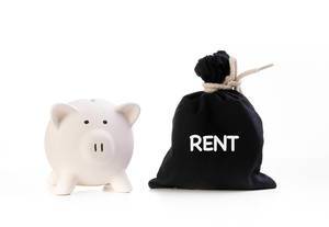 Piggy bank and money bag with Rent text on white background