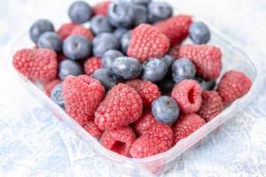 Pile of Blueberries and Raspberries in the plastic package (Flip 2019)
