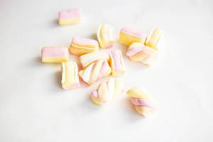 Pile of colorful pink marshmellows on white background
