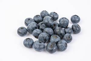 Pile of Fresh Whole Blueberries above white background (Flip 2019)