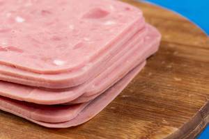 Pile of Sliced Square Ham on the wooden board (Flip 2019)