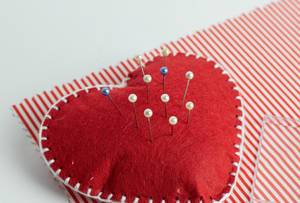 Pincushion with lot of needles and pins for sewing