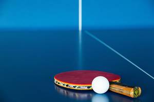 Ping Pong Paddle and Ball on the Table