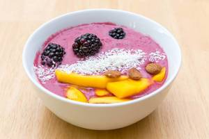 Pink Acai-bowl with berries and coconut