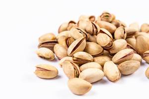 Pistachios above white background