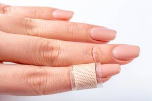 Plaster glued on the finger of a woman