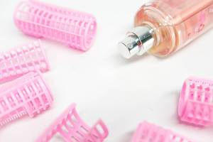 Plastic hair curler tubes and pink spray bottle (Flip 2019)