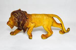 Plastic male lion toy on white surface (Flip 2019)