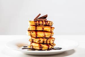 Plate with pancakes and chocolate topping