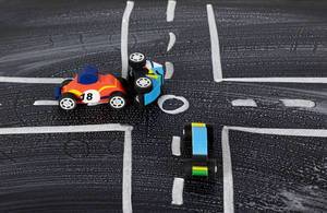 Playing cars on a chalk-painted road crashed