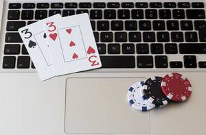 Poker Chips and Cards lies on a Macbook