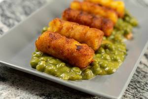 Potato Croquettes with Cooked Green Peas served on the plate