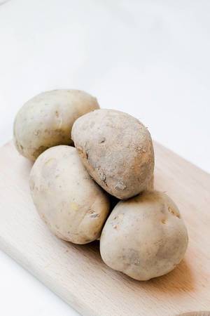 Potatoes on wooden board