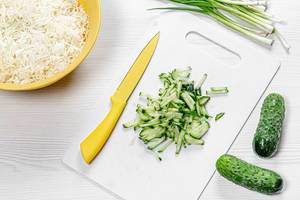 Preparation and cutting of ingredients for salad with cucumber and cabbage (Flip 2019)