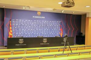 Press room with yellow seats for journalists and small stage for FC Barcelona players and staff members at Camp Nou in Catalonia, Spain