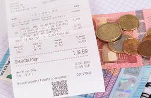 Printed receipt and Euro money closeup