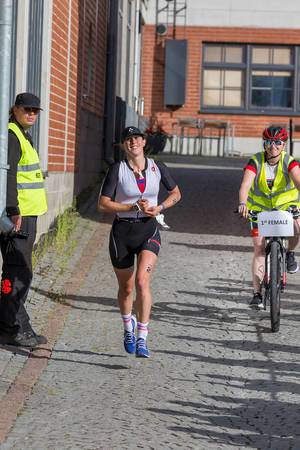 Professional athlete and sportswoman India Lee smiling while running a marathon on first position at the Ironman 70.3 in Lahti, Finland,