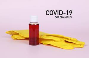 Protective gloves with blood sample and Covid-19 text