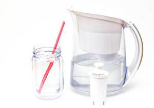 Purified water in a glass to drink on a white background