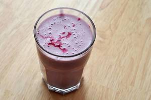 Purple protein shake with red berries, athletic nutrition